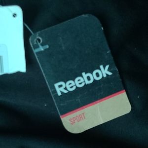 Rebok girls running pants with pink stripes.